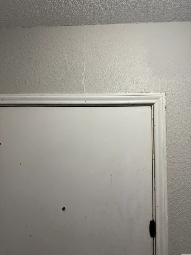 White trim fitted around the inside of the same exterior doorway